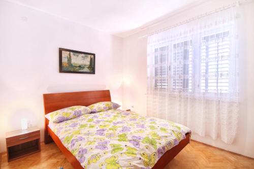a bedroom with a bed and a window at House Romana in Medulin