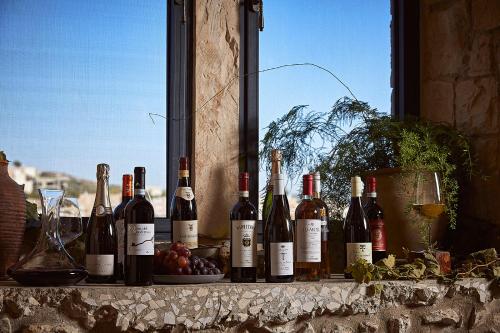 a bunch of wine bottles sitting on a window sill at Chateau du Roi in Mi‘ilyā