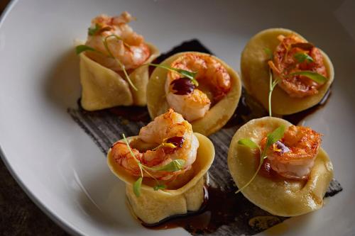 a plate of food with shrimp and vegetables on it at Chateau du Roi in Mi‘ilyā