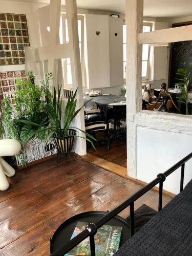 a living room with a table and a fireplace at Quai 17 Maison d'hôtes in Strasbourg