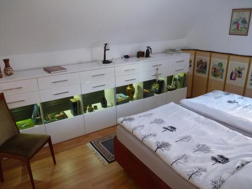 a bedroom with two beds and a dresser with a window at Ferienwohnung GOMO in Stockelsdorf