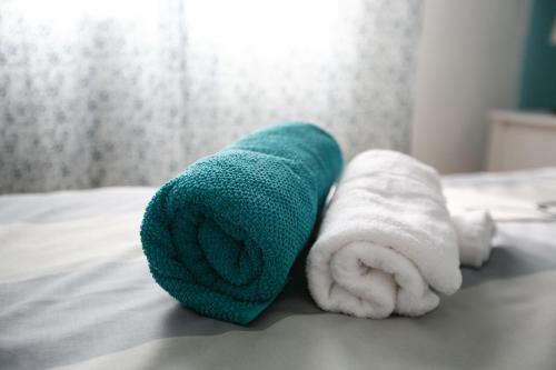 a couple of towels sitting on a bed at Apartments Babin in Vinišće