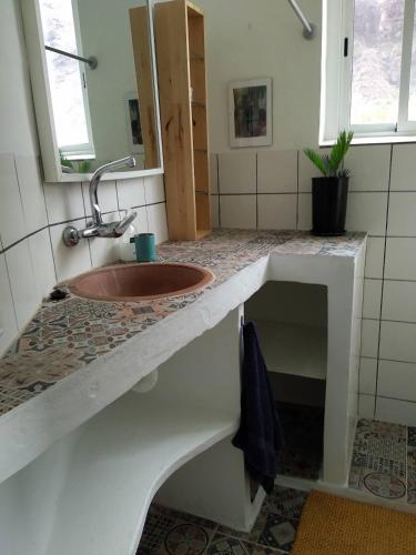 a bathroom with a sink and a counter top at Casa Estie in Calera