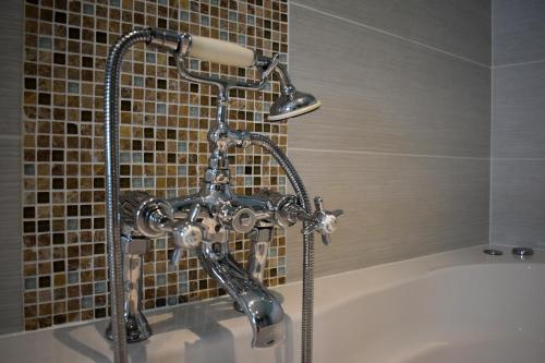 a shower in a bathroom with a bath tub at The Meadows B&B in Moville
