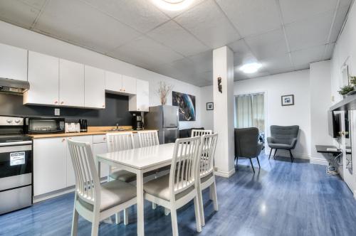 a kitchen and dining room with a table and chairs at 100 METERS to METRO BEAUDRY - FULL APARTMENTS - 1 minute walk to the FAMOUS ST CATHERINE STREET - FAST WIFI - WASHER & DRYER ON SITE - Montcalm units in Montréal