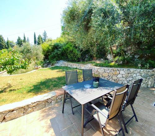 a table and chairs sitting on a patio at Private Sea view house Belonika in Benitses