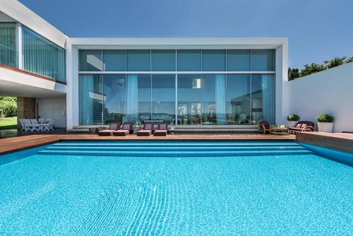 a swimming pool in front of a house at Casa D'Inês in Guimarães