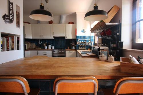 a kitchen with a large wooden table with chairs at Santa Cruz Beach House in Areias
