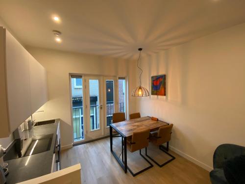 a kitchen and dining room with a table and chairs at Stylish house in the heart of Breda city center in Breda