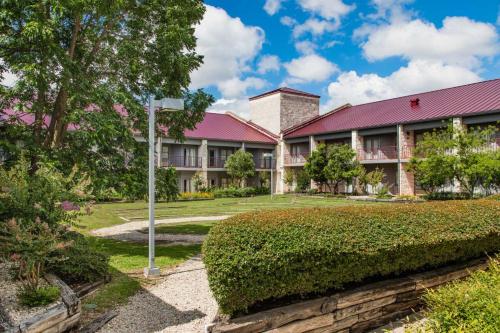 an exterior view of a building with a red roof at Y O Ranch Hotel and Conference Center in Kerrville