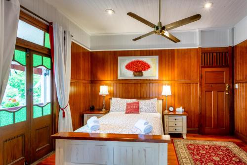 a bedroom with a bed and a ceiling fan at The Village B&B in Gold Coast