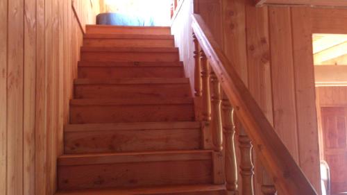 a set of stairs in a log cabin at Cabañas Los Canelos Pucon, Hermosa Granja de 20 hectaréas a orillas del Río Liucura in Pucón