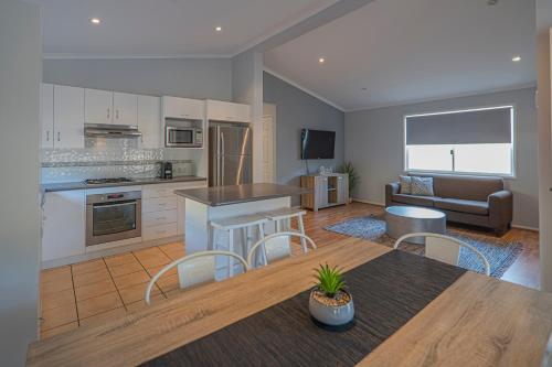 a kitchen and living room with a table and chairs at Ingenia Holidays One Mile Beach in One Mile