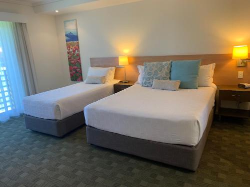 a hotel room with two beds and two lamps at Springs Shoalhaven Nowra in Nowra