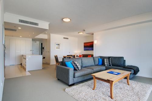 a living room with a couch and a table at Reflections Tower Two in Gold Coast