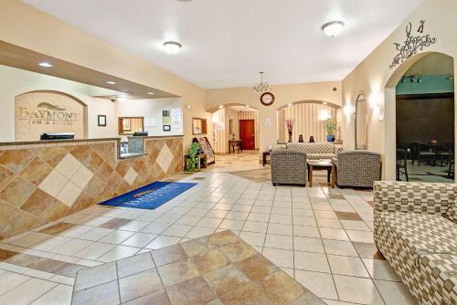 a lobby with a waiting area with chairs and a table at Baymont by Wyndham Decatur in Decatur