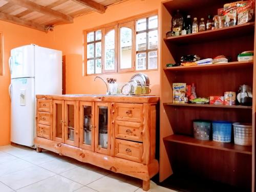 a kitchen with a sink and a refrigerator at El Encanto del Taita Imbabura in Otavalo