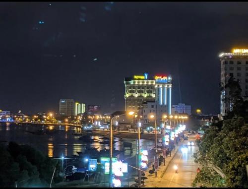 a city lit up at night with buildings and street lights at RiverView Homestay 2 in Xóm Ðé