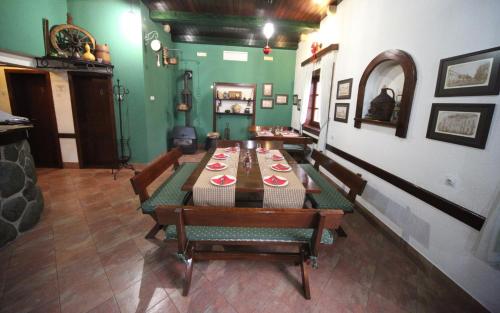 a dining room with a table and chairs and green walls at Hotel Laguna in Podgorica