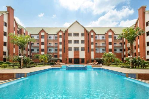 an image of a swimming pool in front of a building at Hawthorn Suites by Wyndham Abuja in Abuja