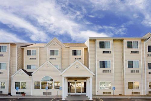 a large apartment building with a lot of windows at Microtel Inn & Suites by Wyndham Prairie du Chien in Prairie du Chien