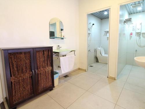 a bathroom with a shower and a sink and a toilet at Hotel JSL in Johor Bahru