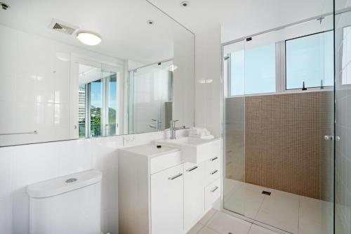 
a bathroom with a sink, mirror, and bathtub at Reflection on the Sea in Gold Coast
