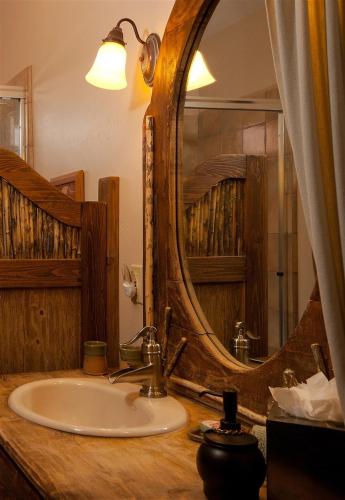 a bathroom with a sink and a large mirror at The Inn at Thunder Mountain in Sedona