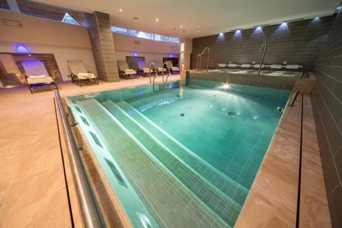 a large swimming pool in a building at Hotel Bellaria in Predazzo