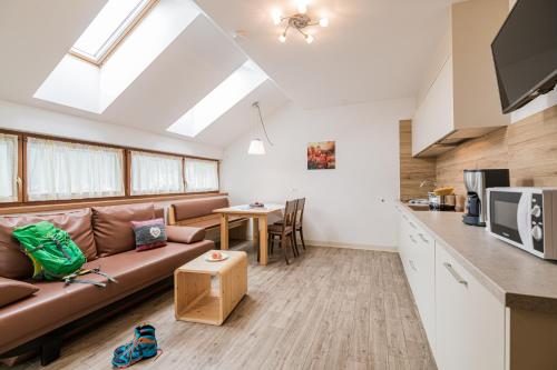 a living room with a couch and a table at Residence Plan De Corones in San Vigilio Di Marebbe