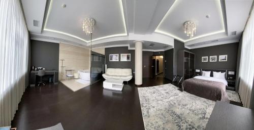 a large bedroom with a bed and a bathroom at Arena in Khmelʼnytsʼkyy