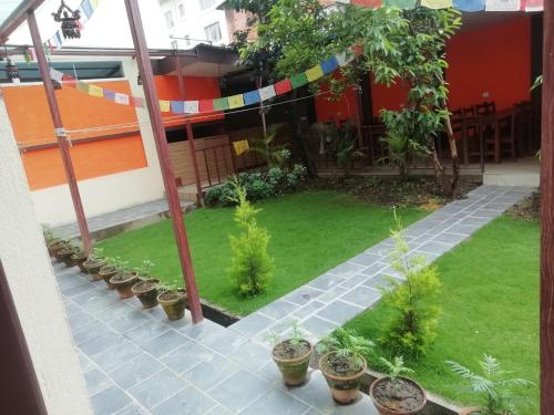 a garden with potted plants on a patio at Hotel Chhimeki in Kathmandu
