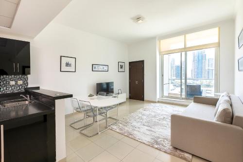 a living room with a couch and a table at Great Location 1BR Botanica Dubai Marina in Dubai