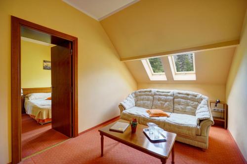 伯伊萊圖什納德的住宿－丘卡什酒店，客厅配有沙发和桌子