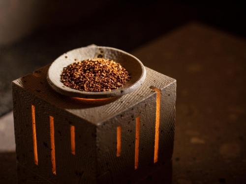 a block with a small bowl of seeds on it at ONSEN RYOKAN Yuen Sapporo in Sapporo