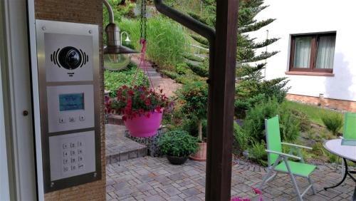 a patio with potted plants and a table and chairs at Ferienwohnung am Silberg in Plettenberg