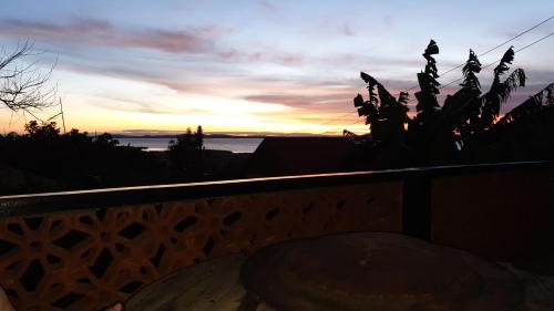 a view of the sunset from the balcony of a house at Alison & Dave's Guesthouse in Entebbe