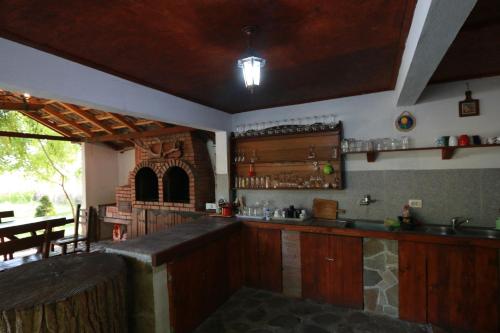 a kitchen with wooden cabinets and a counter top at La Livada in Greci