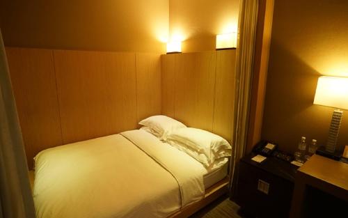 Кровать или кровати в номере City Suites-Taipei Nanxi