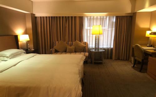 Кровать или кровати в номере City Suites-Taipei Nanxi