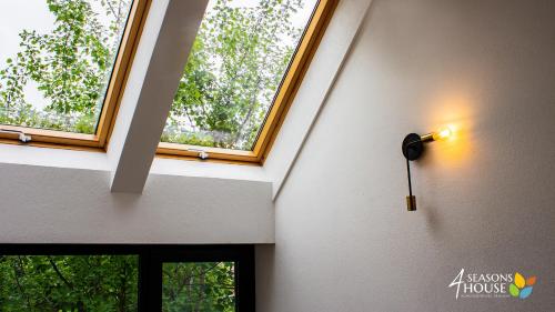 a room with two windows and a light on the wall at 4 Seasons - House in Sub Cetate