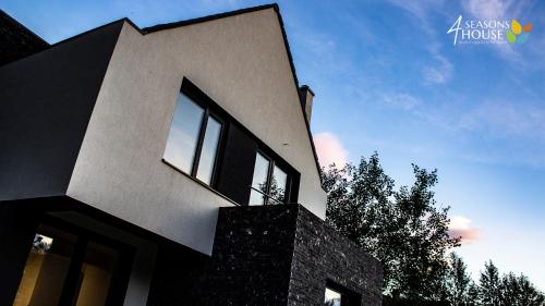 a black and white house with a sky at 4 Seasons - House in Sub Cetate