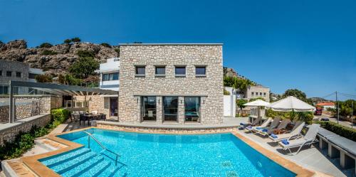 a swimming pool in front of a house at Villa CostaMare - enjoy lazy days on the private Pool-Jacuzzi in Pefki Rhodes