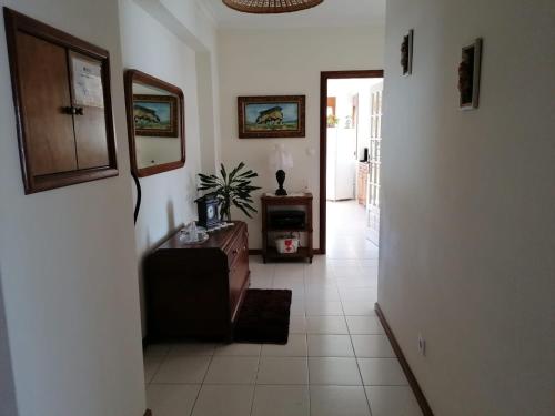 a hallway with a living room with a couch and a table at Apartamento T3 Amorosa in Viana do Castelo