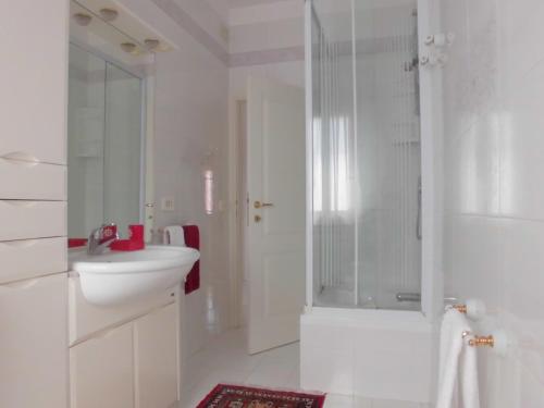 a white bathroom with a sink and a shower at Solare B&B in Mestre