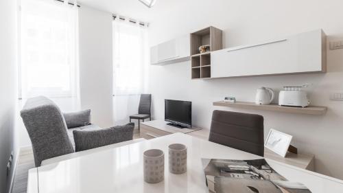 a white living room with a table and chairs at Italianway - Savona 146 in Milan