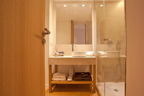 a bathroom with a sink and a shower at Mon Port Hotel & Spa in Port d’Andratx