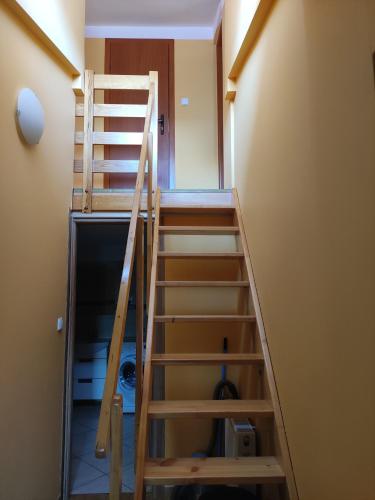 a ladder leading up to a room with a closet at Apartament przy plaży in Kuźnica