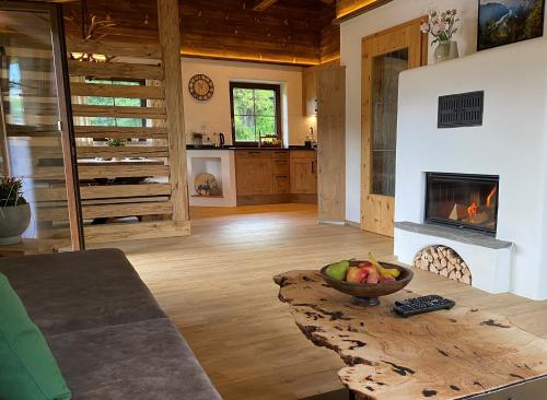 a living room with a table and a fireplace at Ferienhaus Berggfui in Berchtesgaden