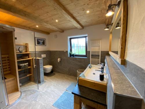 a bathroom with a sink and a toilet at Ferienhaus Berggfui in Berchtesgaden